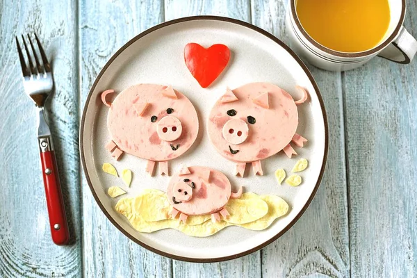 Cute family of pigs food art idea for children\'s breakfast. symbol of 2019, Top view.