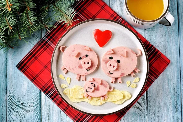 Cute family of pigs food art idea for children\'s breakfast. symbol of 2019, Top view.
