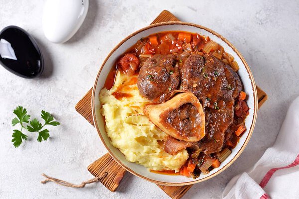 Beef shank stew with onions, carrots, celery, tomatoes, thyme and wine. Top view.