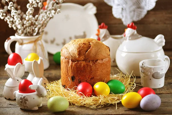 Traditional Easter food - eggs and Easter cake on an old wooden table. Easter background.