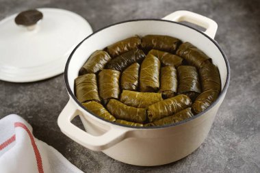 Dolma (tolma, sarma) - stuffed grape leaves with minced meat, rice, onion and carrot. Traditional Greek, Turkish, Ottoman and Caucasian cuisine. clipart