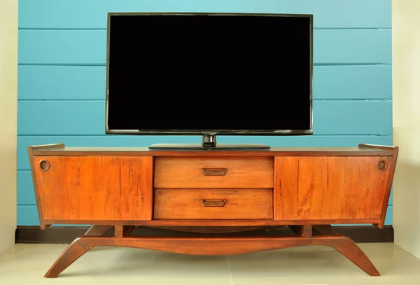 retro Television cabinet in room against blue wall