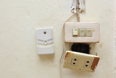 a light switch and electrical socket switch with damaged wiring on the wall clipart