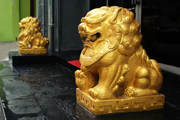 Chinese gold color lions decoarate at the entrance of home