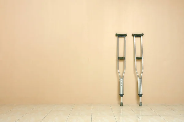 Crutches against a wall and copy space.