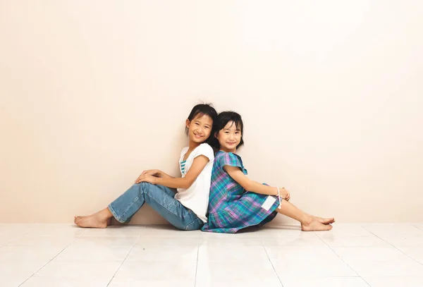 Cute Smiling Asian Siblings Sit Touch Each Other Backs Lovely — Zdjęcie stockowe