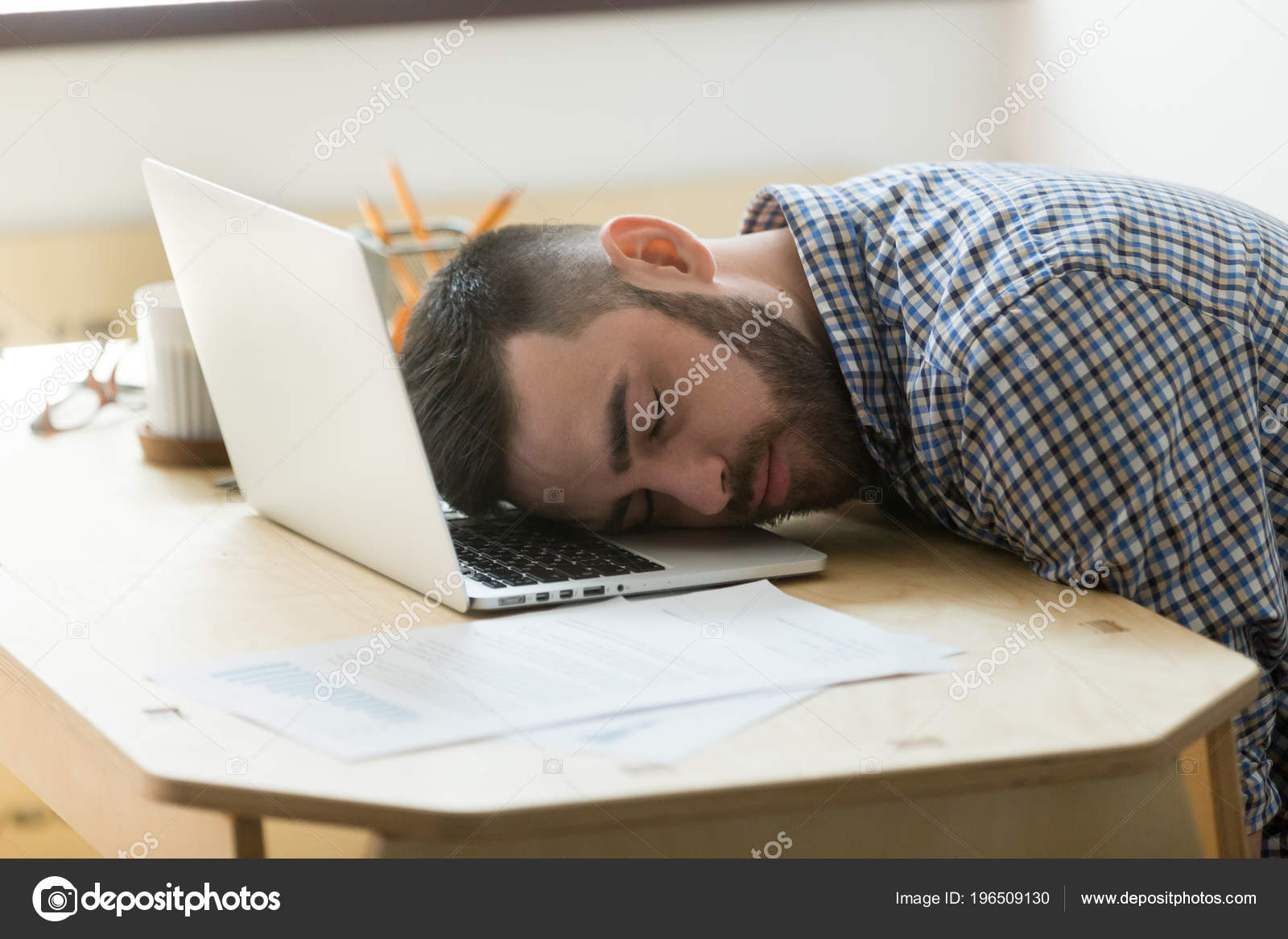 Tired Male Worker Sleeping At Laptop At Office Desk Stock Photo