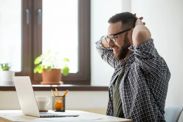 Happy male stretching satisfied with good news — Stock Photo, Image