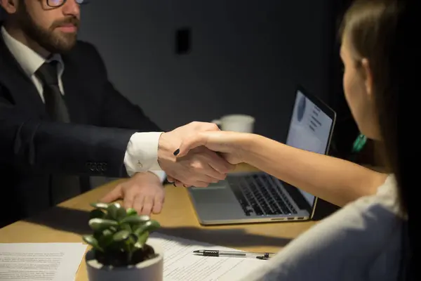 Businessman shaking hand of female partner in office — Stock Photo, Image