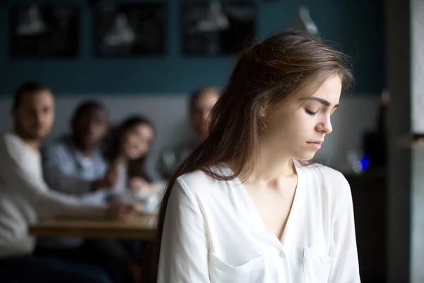 Sad young woman avoiding friends suffering from gossiping or bul — Stock Photo, Image