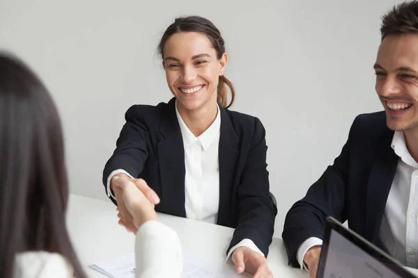 Smiling female hr handshaking businesswoman at group meeting or — Stock Photo, Image