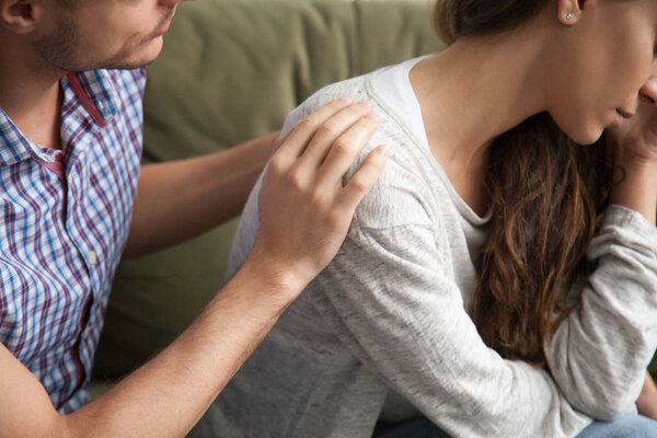 Helping caring husband apologizing comforting wife, support in m