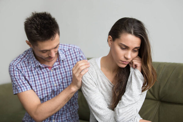 Husband supporting comforting upset depressed wife, infertility 