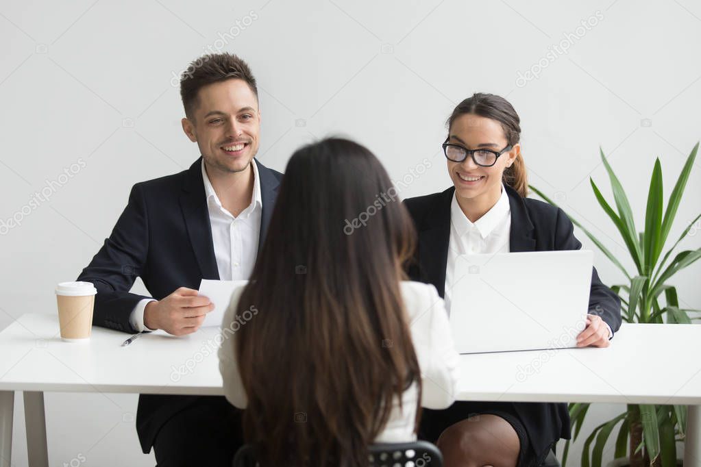 Smiling friendly hr managers interviewing female applicant, good