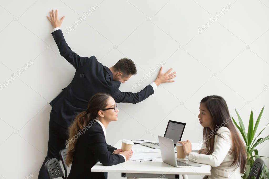 Businessman getting bored of dull work routine at team meeting