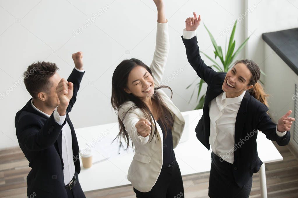 Victory dance concept, excited diverse coworkers celebrating bus