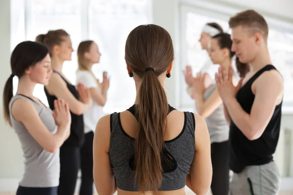 Group of young sporty people in Namaste — Stock Photo, Image