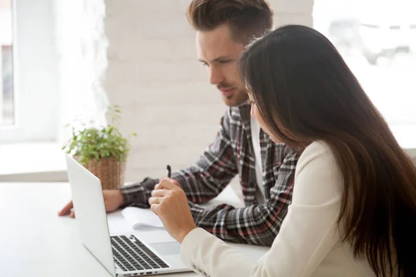 Thoughtful colleagues analyzing company financial stats together — Stock Photo, Image