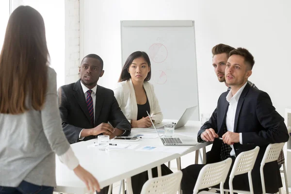 Diverse team being judgmental scolding unpunctual colleague — Stock Photo, Image