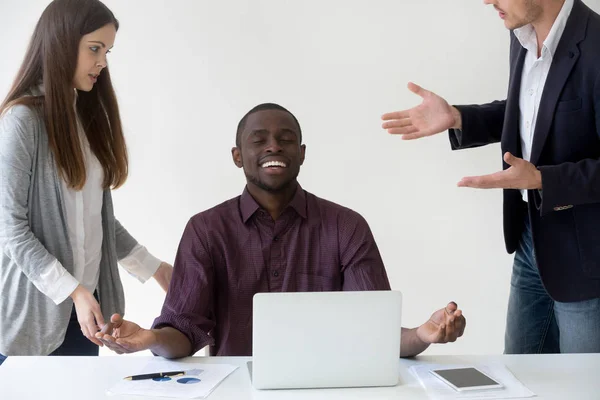 Happy African American worker mediating reaching nirvana at work