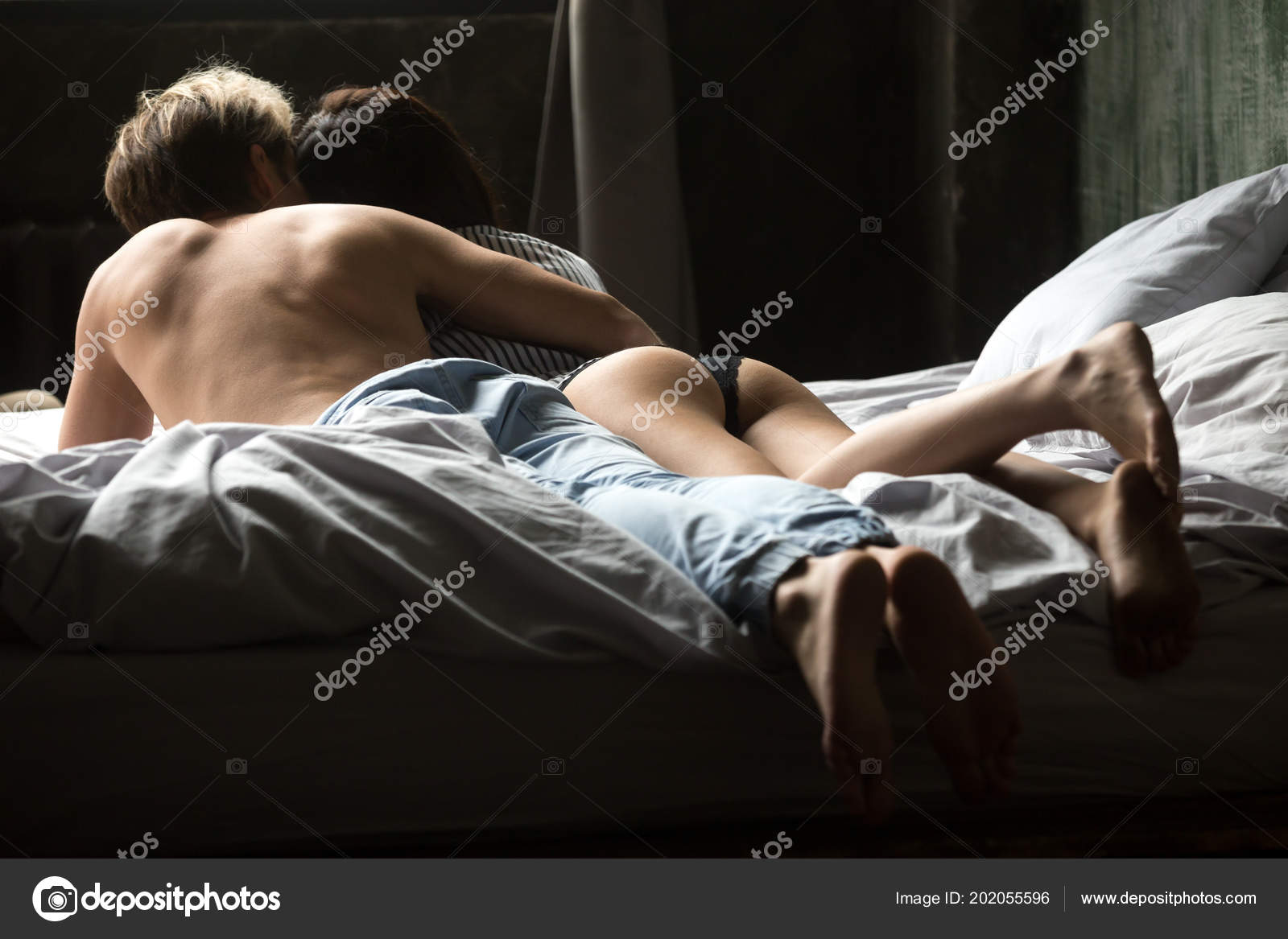 Sexy Couple Enjoying Morning In Bed Hugging And Kissing