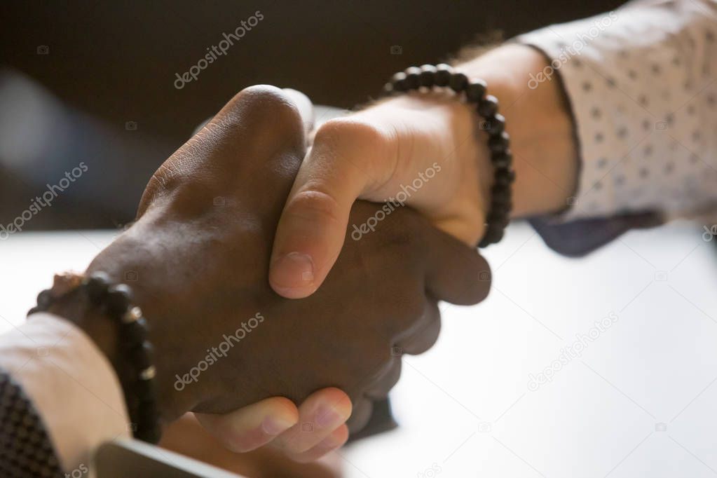 Multiracial people handshaking greeting with achievement or succ