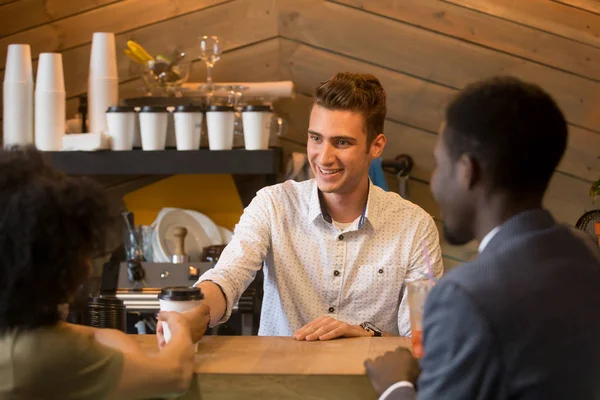 Caucasian barista serving coffee to black girl during date — Stock Photo, Image