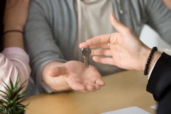Close up of couple receiving keys to new home — Stock Photo, Image