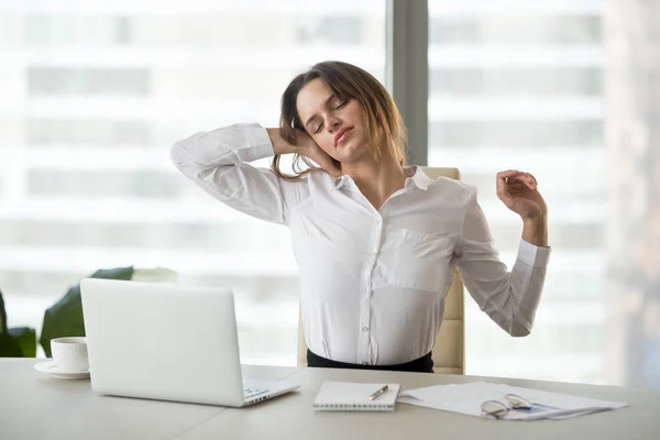Exhausted businesswoman taking break from sedentary work stretch — Stock Photo, Image