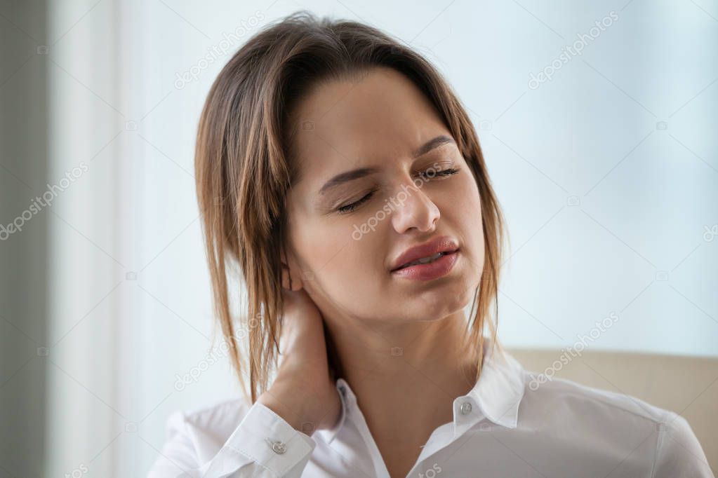 Exhausted businesswoman massage neck suffering from muscle pain