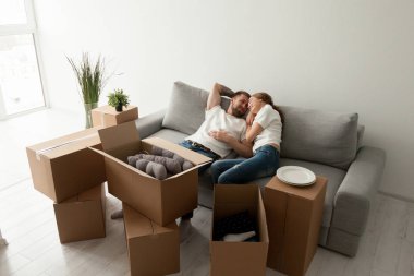 Sevgi dolu koca yan yana ilk paylaşılan dairede kanepede yatarken