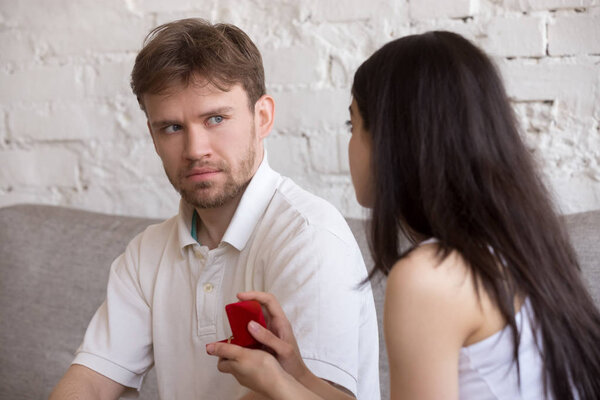 Decisive woman asking puzzled lover to marry her