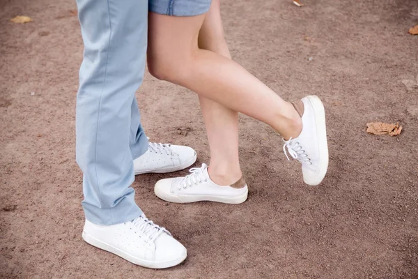 Close up of legs of romantic couple hugging in park — Stock Photo, Image