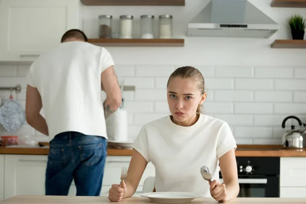 Hongerige vrouw kijken ontevreden wachten man koken — Stockfoto