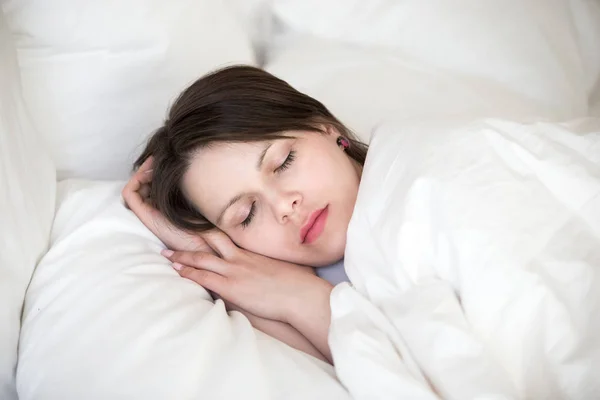 Woman sleeping in bed on orthopedic pillow covering with duvet — Stock Photo, Image