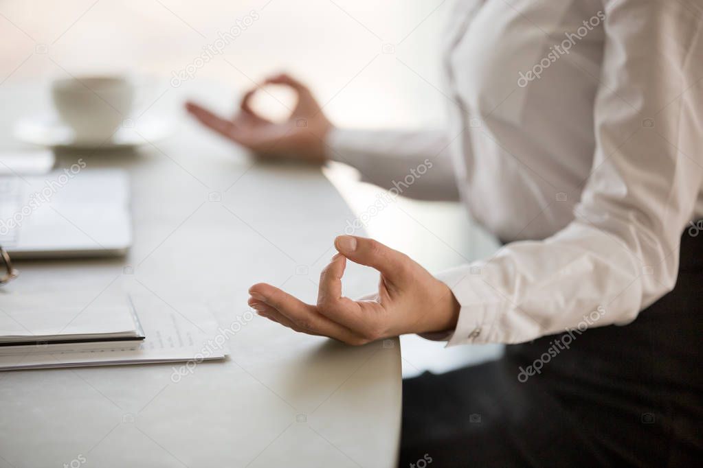 Office meditation for reducing work stress concept, female hands