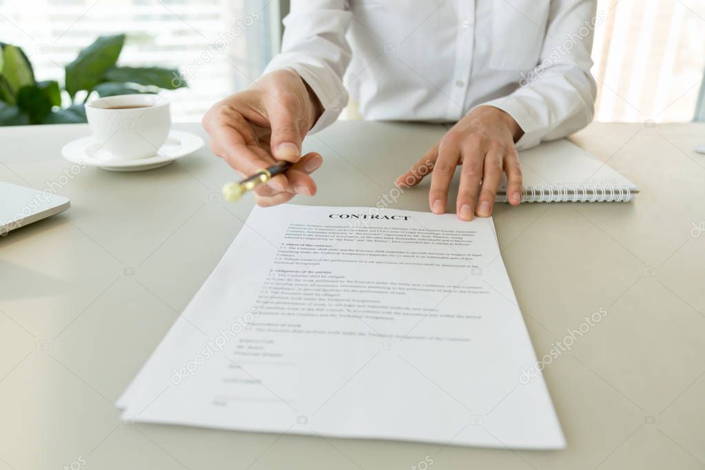 Woman giving pen offering to sign contract promising good deal 