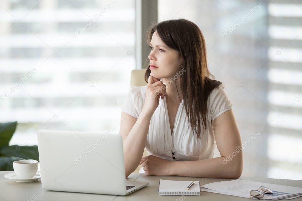Thoughtful doubtful businesswoman looking away thinking of probl