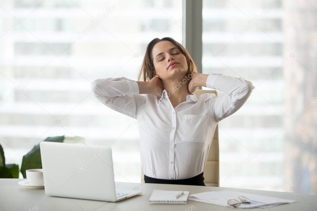 Businesswoman taking work break doing office exercises massaging