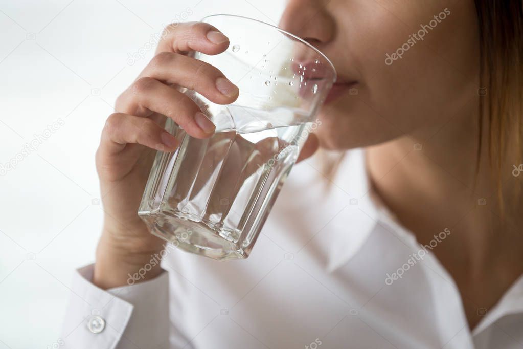 Dehydrated woman feeling thirsty holding glass drinking water, h