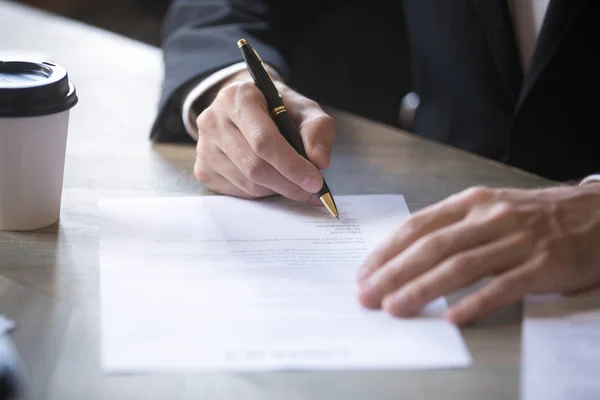 Close up man hands on the table, the man signing the contract — Stock Photo, Image