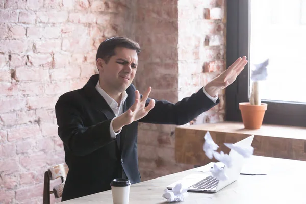 Stressed tired and annoyed employee throwing crumpled paper — Stock Photo, Image