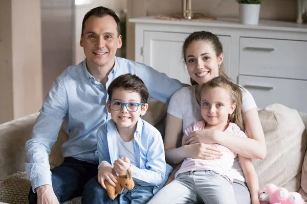 Retrato de feliz jovem família de quatro posando para foto — Fotografia de Stock