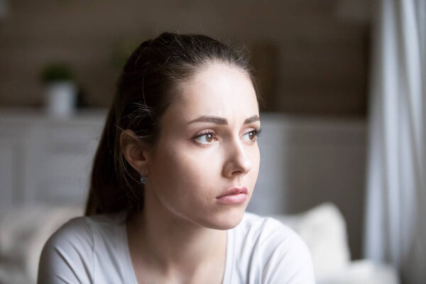 Sad woman looking far away thinking about personal problems