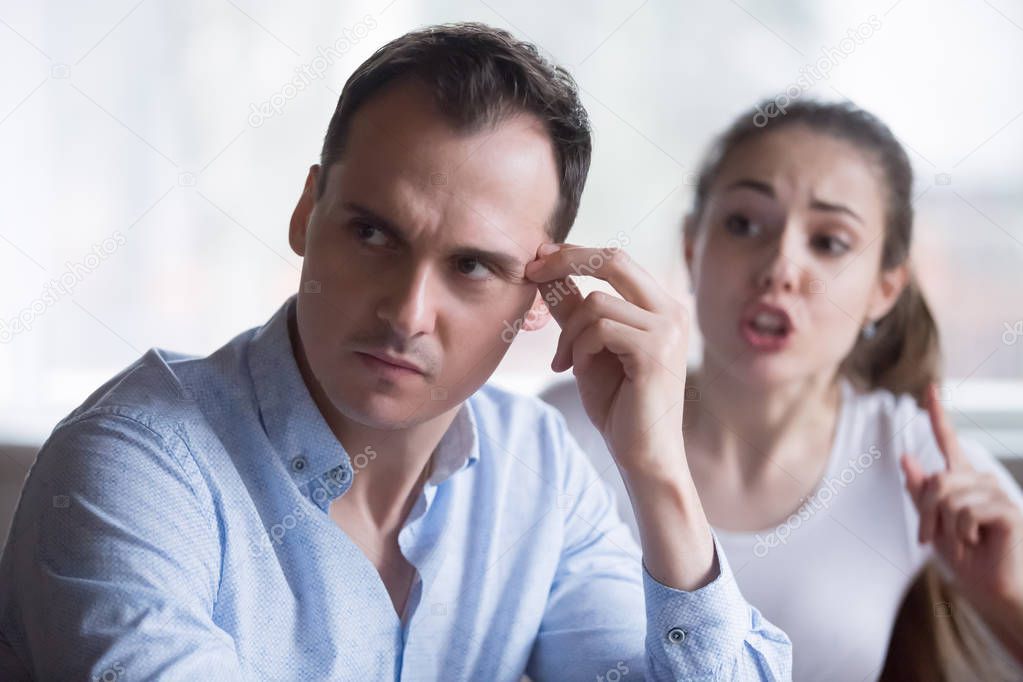 Bothering woman lecturing annoyed husband during fight