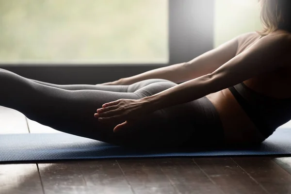 Sporty woman doing spine muscle strengthening exercise — Stock Photo, Image