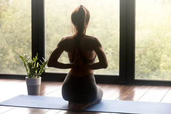 Young sporty woman doing yoga vajrasana exercise — Stock Photo, Image