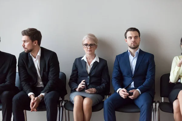 Young and mature candidates waiting for job interview in office — Stock Photo, Image