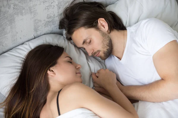 Loving millennial couple sleep together holding hands — Stock Photo, Image