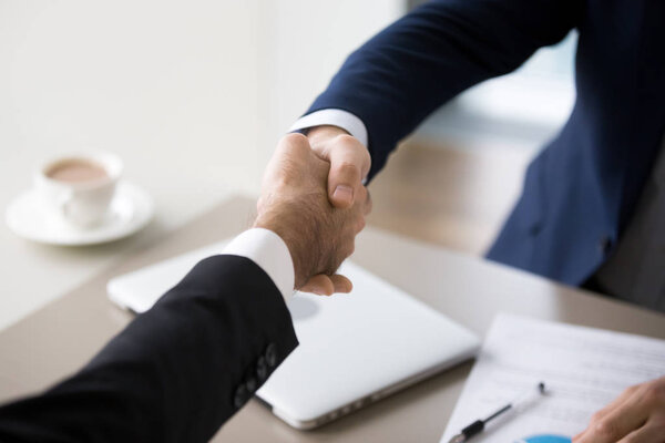 Close up of business colleagues handshake after successful meeti